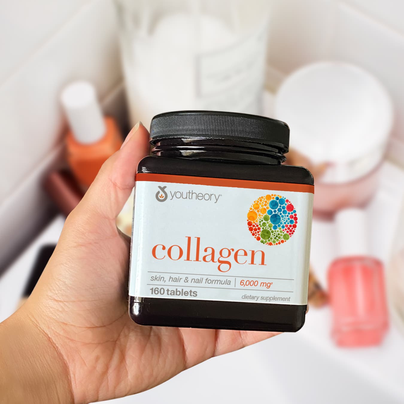 collagen tablets bottle in hand