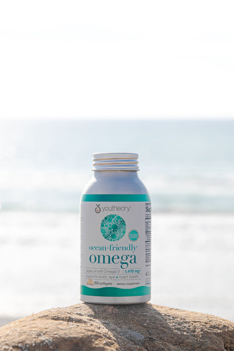 ocean-friendly omega bottle on a rock at the oceanside